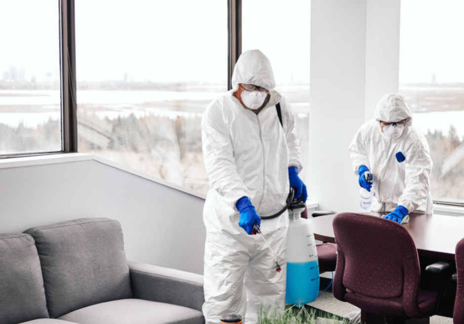 Image of workers disinfecting surfaces in office
